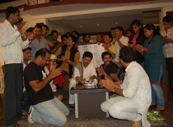 Vinay Apte cuts the cake with his Durva Family