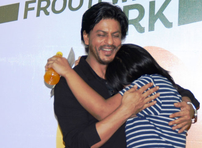 An emotional fan hugs SRK at the Frooti meet & greet event