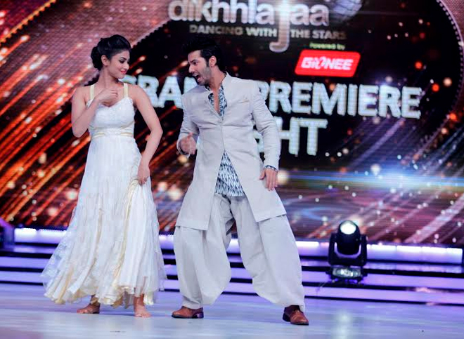 Varun Dhawan dances with contestant Mouni Roy.